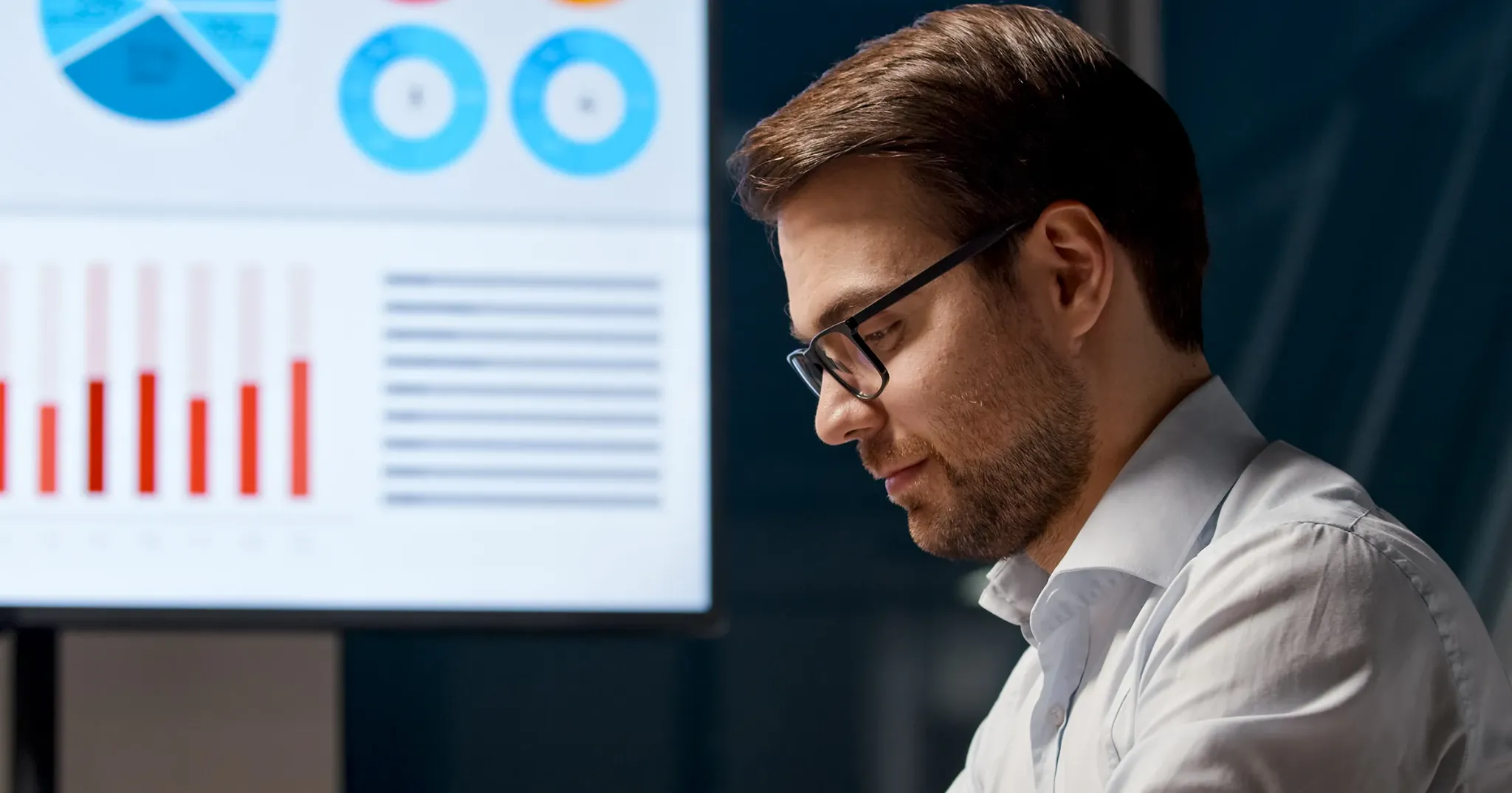 Business professional reviewing charts on screen while evaluating AI workflow information