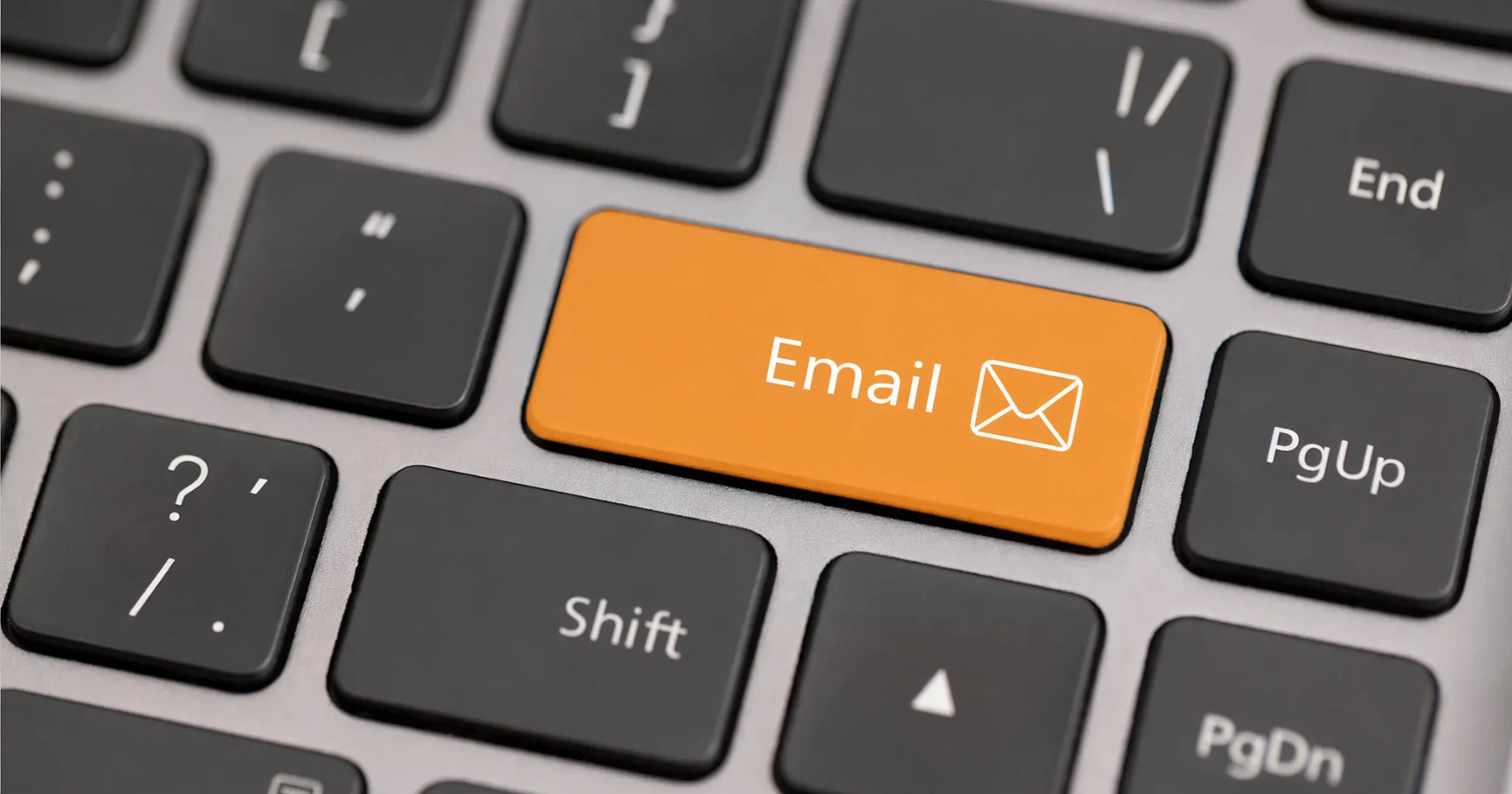 Close-up of a keyboard with an ochre Email key representing email authentication and deliverability