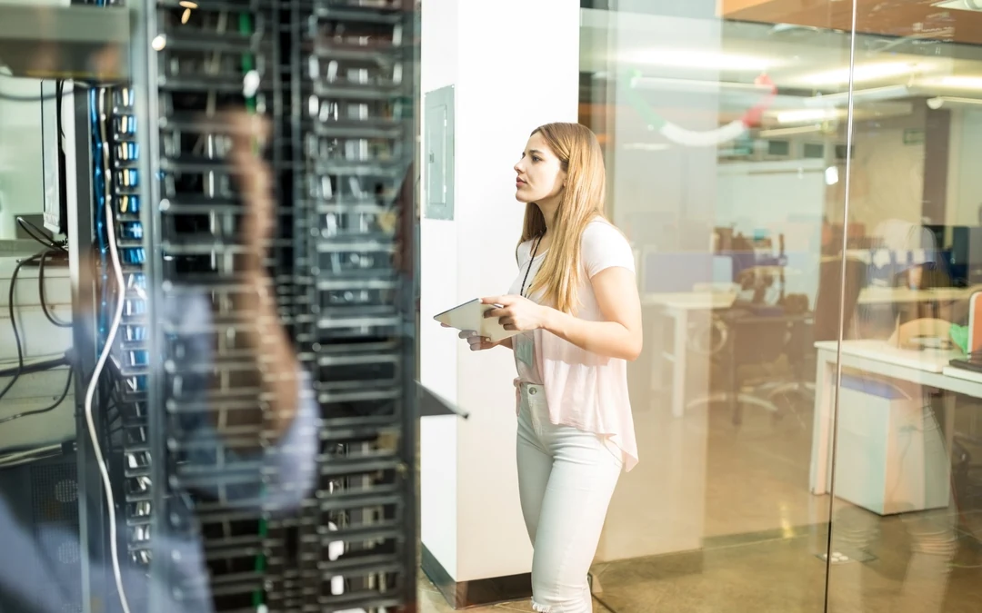 Technician inspecting server equipment in a data centre