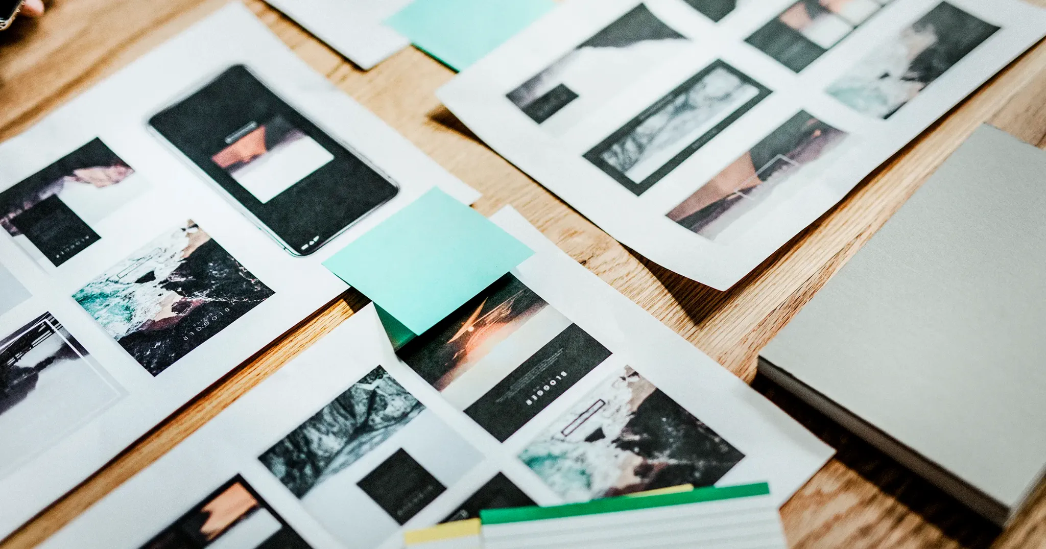 Printed website layout and portfolio design mockups on a desk