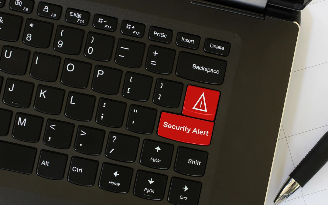 Laptop keyboard with a red security alert key